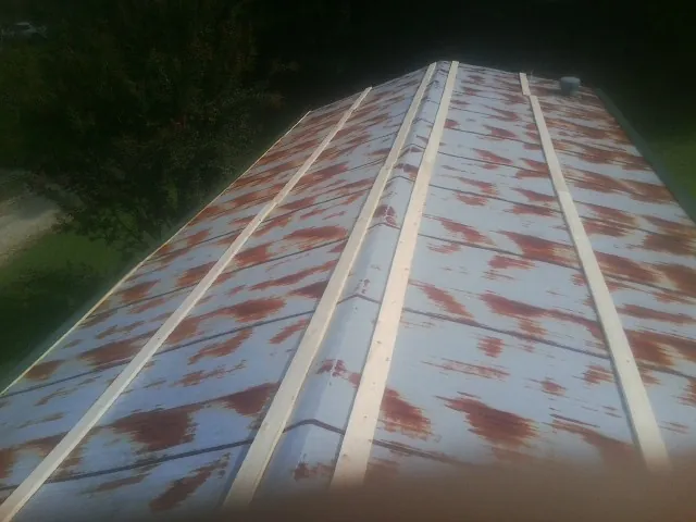 Rusted metal roof panels with new wood purlins before replacement — Storm Damage Roof Repair in Ashwood by Roofing Brothers
